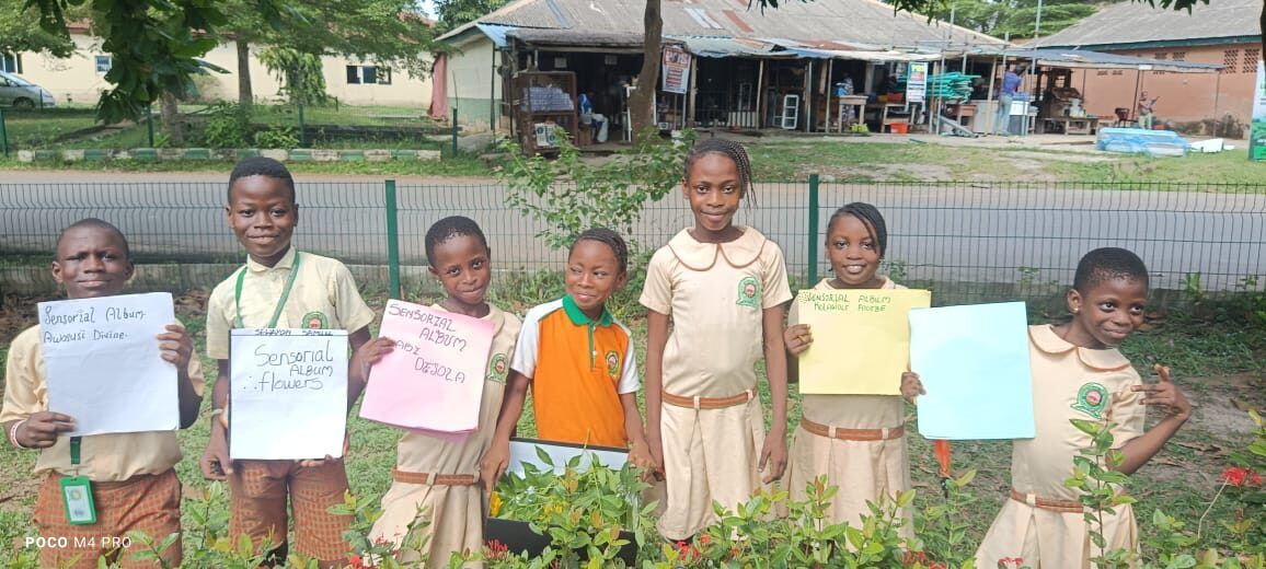 An ROIS pupil on stage with a spelling bee prize check